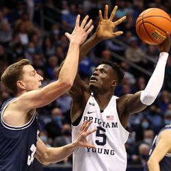Utah State Aggies forward Justin Bean (34) defends Brigham Young Cougars forward Gideon George (5) as BYU and Utah State play an NCAA basketball game in Provo at the Marriott Center on Wednesday, Dec. 8, 2021. BYU won 82-71.