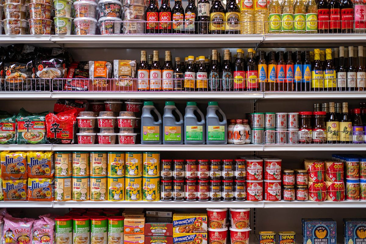 Rows of sauces and condiments inside of an Asian grocery store.
