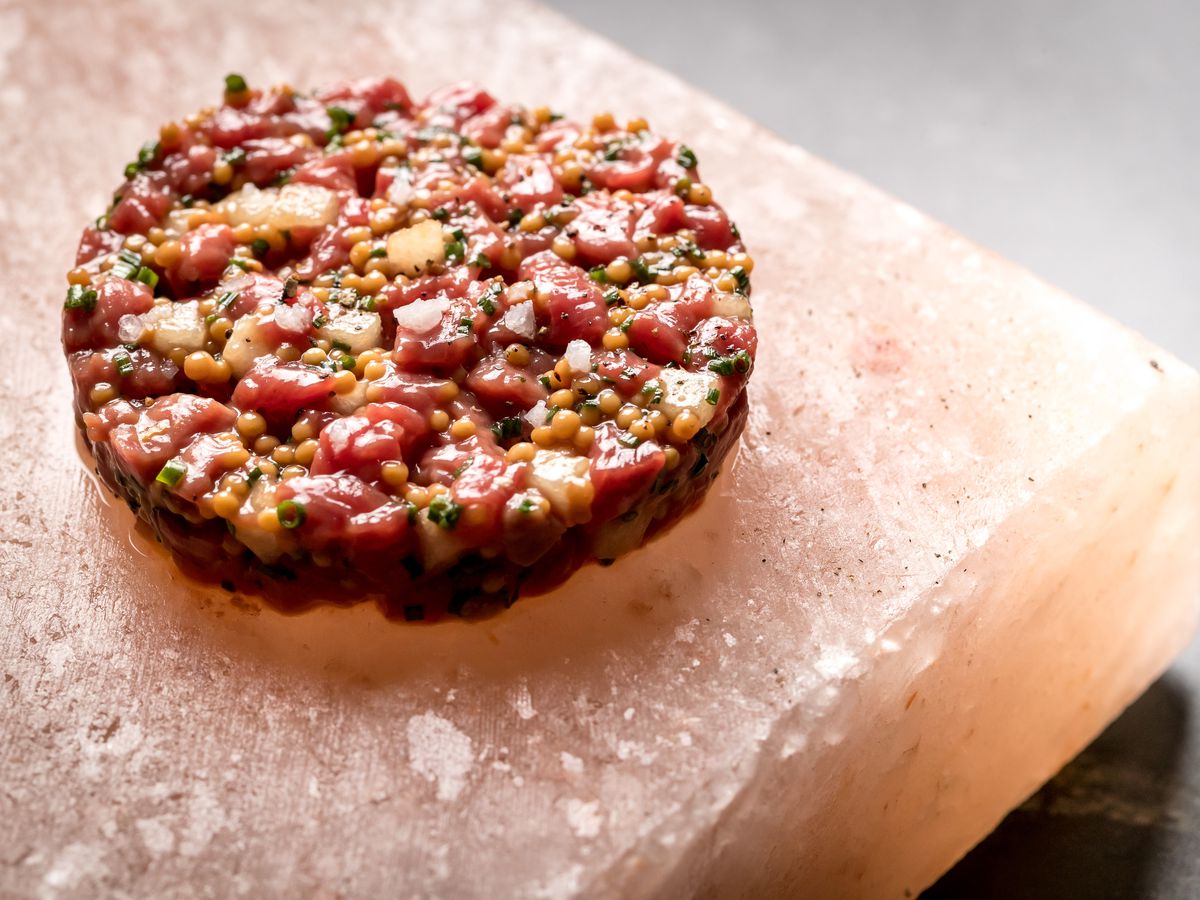 Cote’s beef tartare sits over pink salt