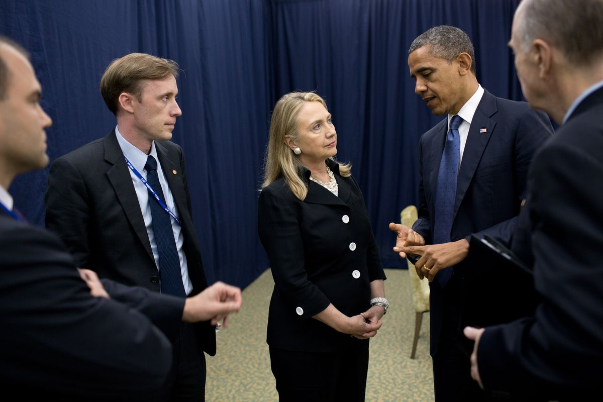 Jake Sullivan listens as President Barack Obama talks with Secretary of State Hillary Clinton in Cambodia about his decision to dispatch her to help broker a cease-fire in the Middle East in November 2012