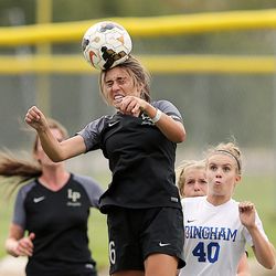 Lone Peak's Nicole Ray heads the ball over Bingham's Kallie James as they two teams compete in soccer action at Lone Peak on Tuesday, Aug. 22, 2017. Lone Peak won 2-1.