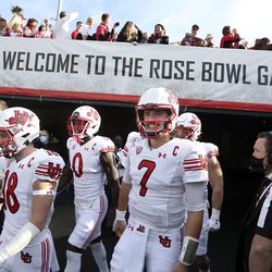 Utah Utes long snapper Keegan Markgraf, wide receiver Britain Covey, linebacker Devin Lloyd, quarterback Cameron Rising and defensive end Mika Tafua (42) walk onto the field for the game against Ohio State in the Rose Bowl in Pasadena, Calif., on Saturday, Jan. 1, 2022.