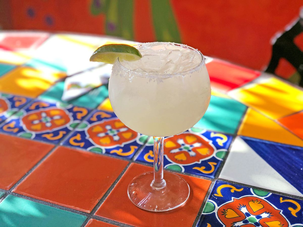 Pale cocktail on colorful tile table. 