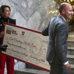 University of Utah President Ruth V. Watkins and Lt. Gov. Spencer Cox present members of the Utah Coal Country Strike Team with a check for being one of three finalists in the American Dream Ideas Challenge during ceremony at the University of Utah in Salt Lake City on Thursday, Nov. 29, 2018.