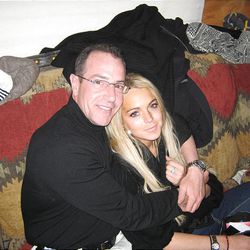 Michael Lohan hugs his daughter, Lindsay, following her release from rehab.