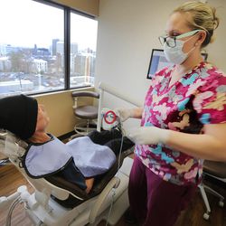 Dental assistant Ally Thompson prepares to take an X-ray of Derick Balser's teeth at South Temple Dental in Salt Lake City on Monday, March 21, 2016, prior to Dr. Spencer Updike conducting free dental screening to help Balser with his dental health.