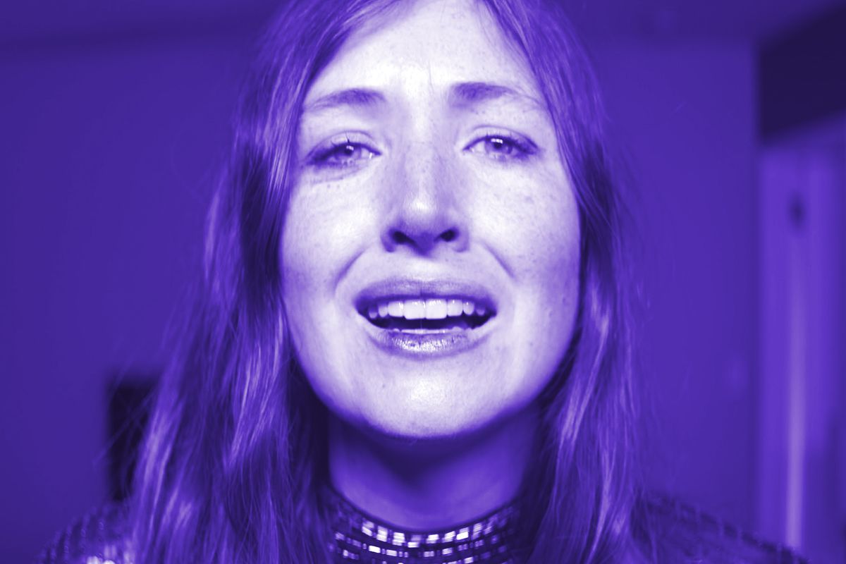 Kate Lyn Sheil in close-up purple light in She Dies Tomorrow