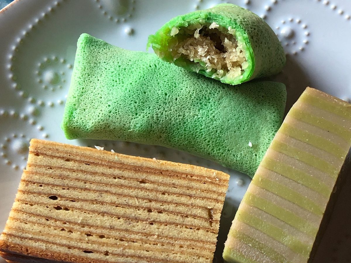Green and brown desserts are displayed on a white patterned plate.
