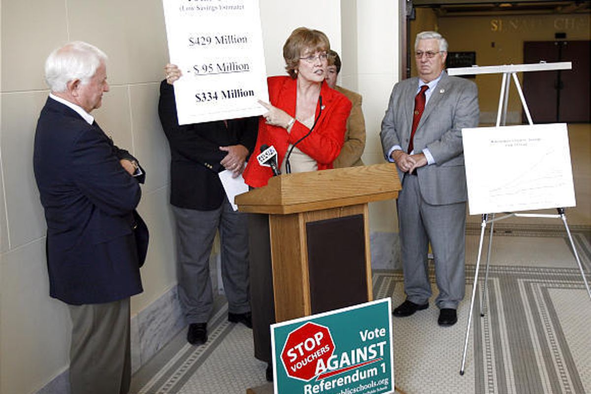Rep. Sheryl Allen displays anti-voucher charts with other GOP lawmakers, including Rep. Kay McIff, left, and Rep. Steve Mascaro.