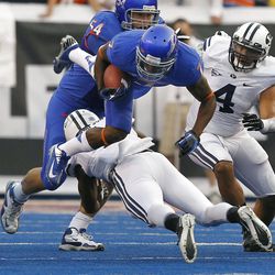 Joe Sampson (1) of the Brigham Young Cougars upends D.J. Harper (7) of the Boise State Broncos during NCAA football in Boise, Thursday, Sept. 20, 2012. 