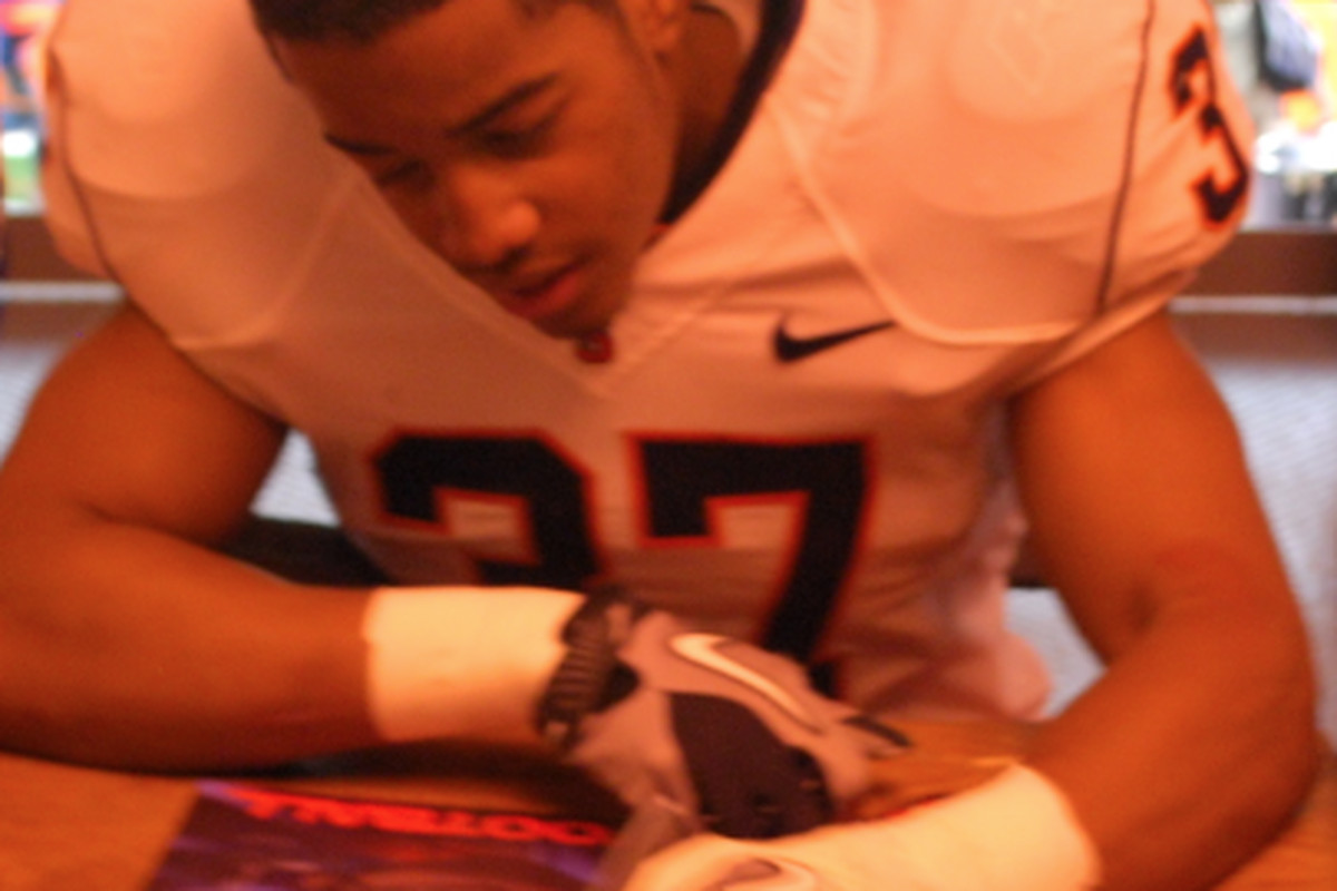 Williamson signing a poster at the spring game...