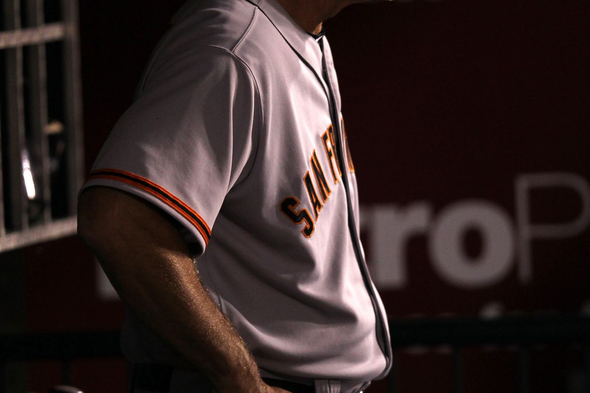 The lights dim as Bruce Bochy's head emerges from the dugout.
