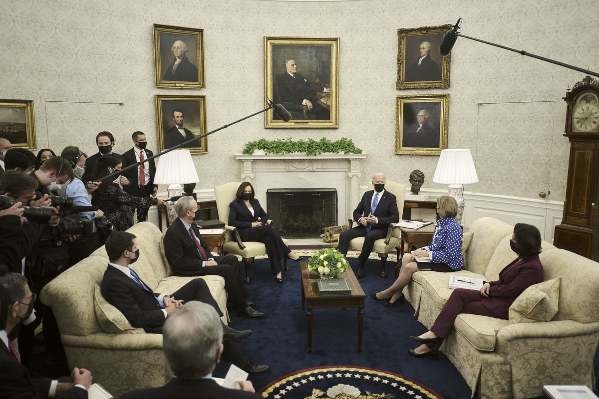 US President Joe Biden, center right, wears a protective mask while speaking during a meeting in the Oval Office of the White House in Washington, DC, on May 13, 2021.