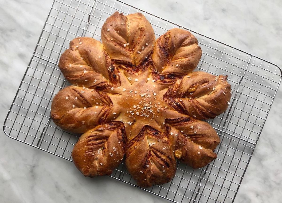 A bread in the shape of a star on a cooling rack