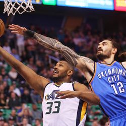 Utah Jazz center Boris Diaw (33) gets off a layup in front of Oklahoma City Thunder center Steven Adams (12) as the Jazz and the Thunder play at Vivint Smart Home arena in Salt Lake City on Wednesday, Dec. 14, 2016.