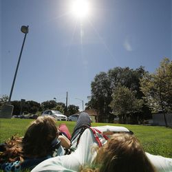 An Innovations Early College High School student and teacher watch the solar eclipse in Salt Lake City on Monday, Aug. 21, 2017.