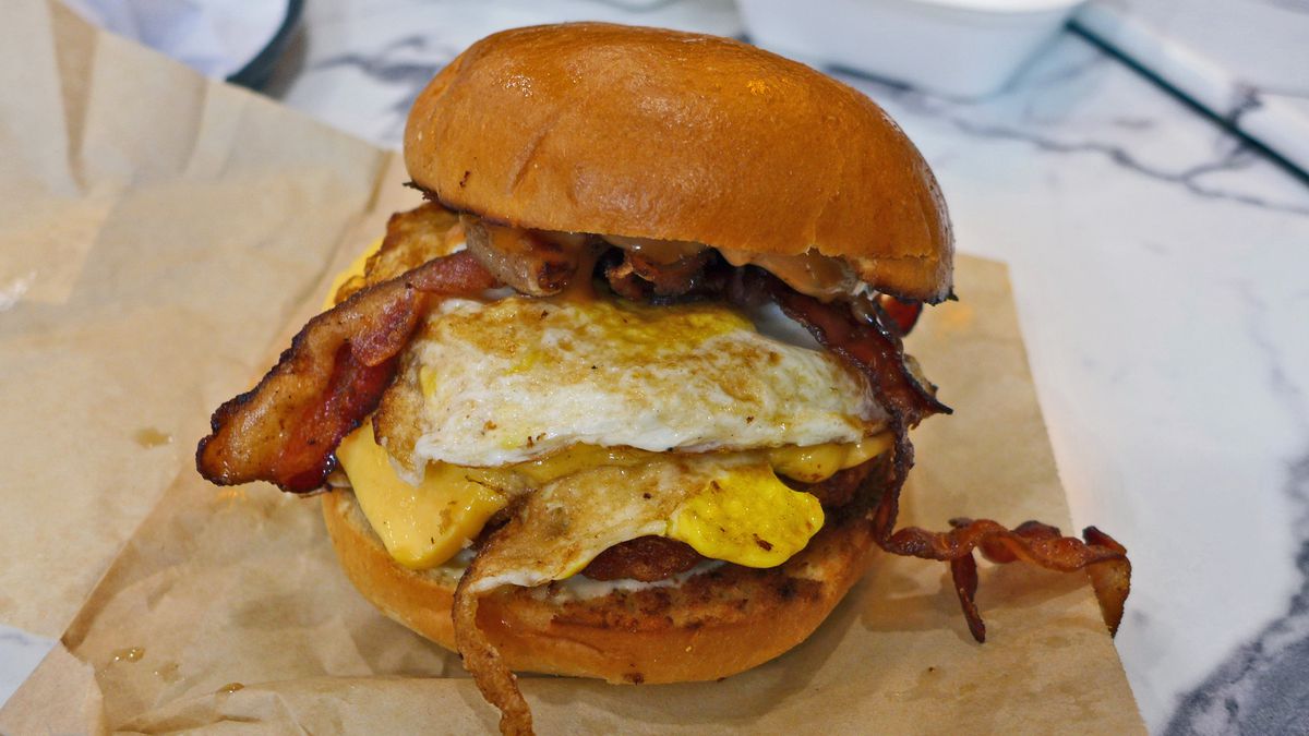 A thickly piled breakfast sandwich.