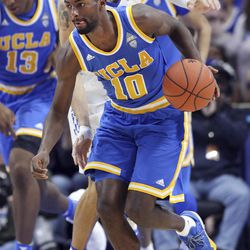 UCLA's Isaac Hamilton (10) advances the ball in front of Kentucky's Derek Willis during the second half of an NCAA college basketball game, Saturday, Dec. 3, 2016, in Lexington, Ky. UCLA upset No. 1 Kentucky 97-92. 