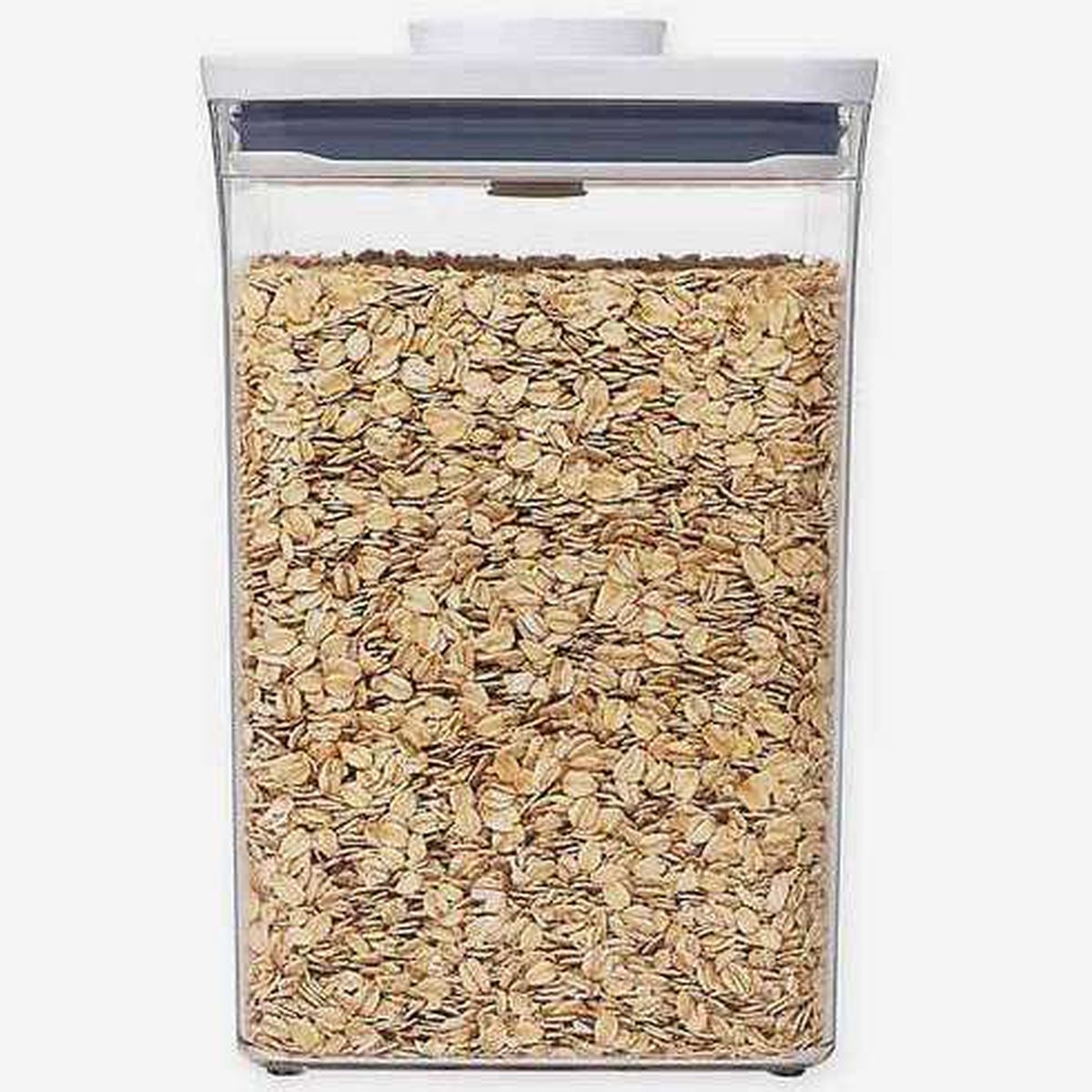 A clear plastic container full of oats