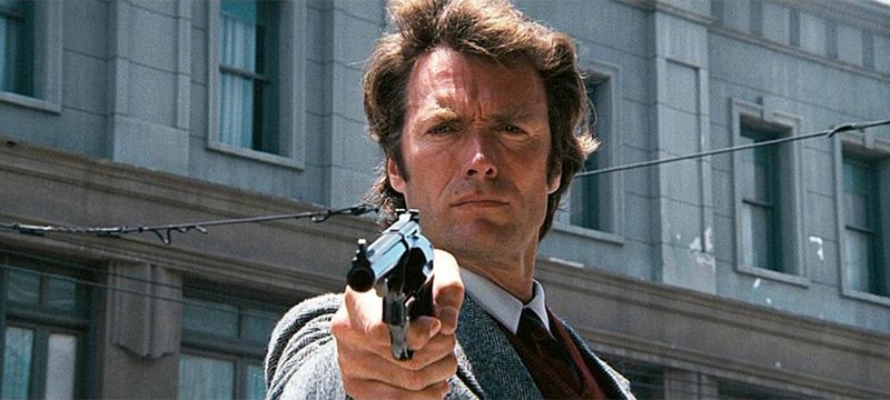 Clint Eastwood points a gun.