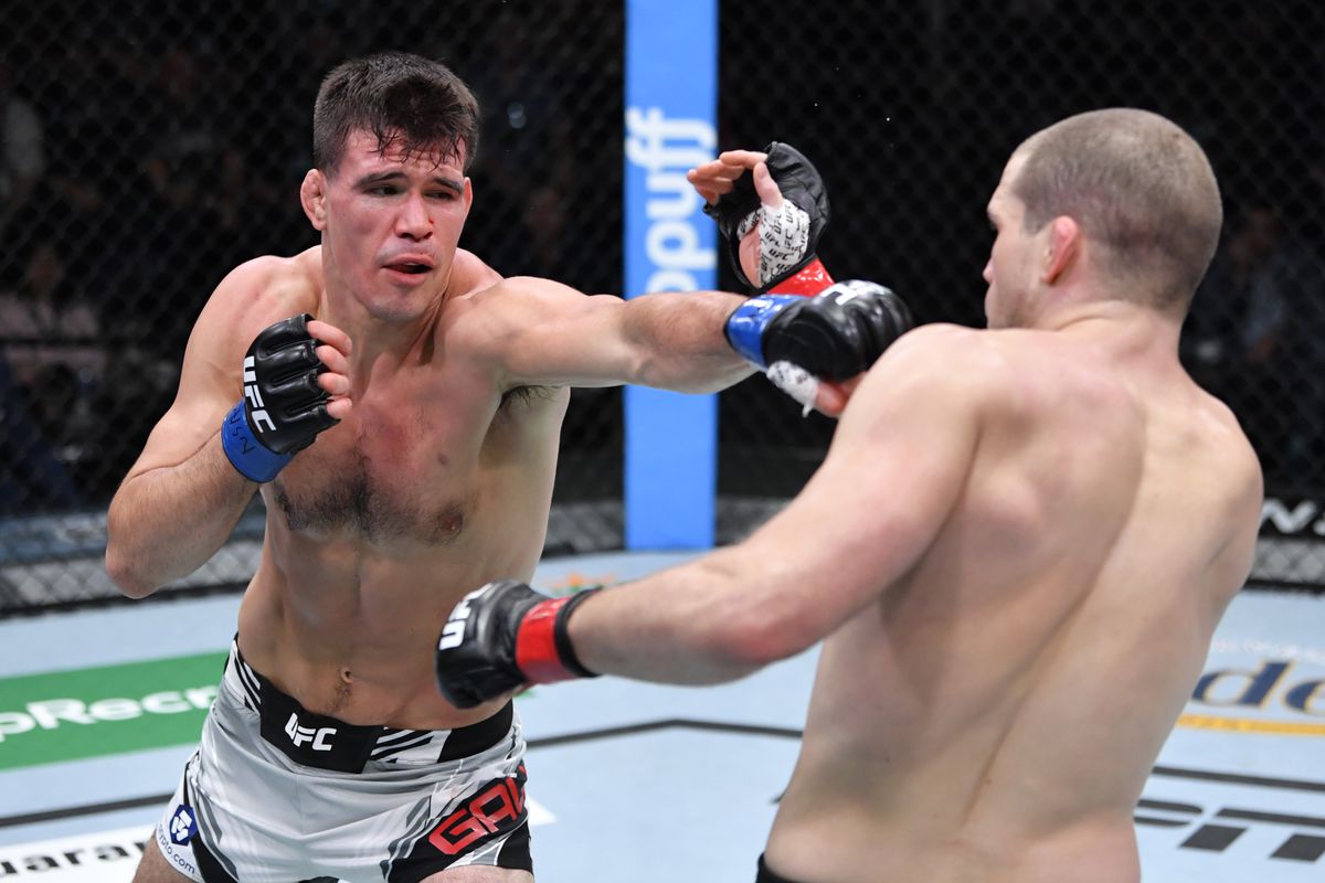 Mickey Gall punches \am in their welterweight fight during the UFC Fight Night event at UFC APEX on December 04, 2021 in Las Vegas, Nevada.