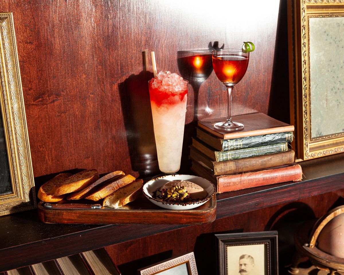 A series of cocktails a bookshelf.