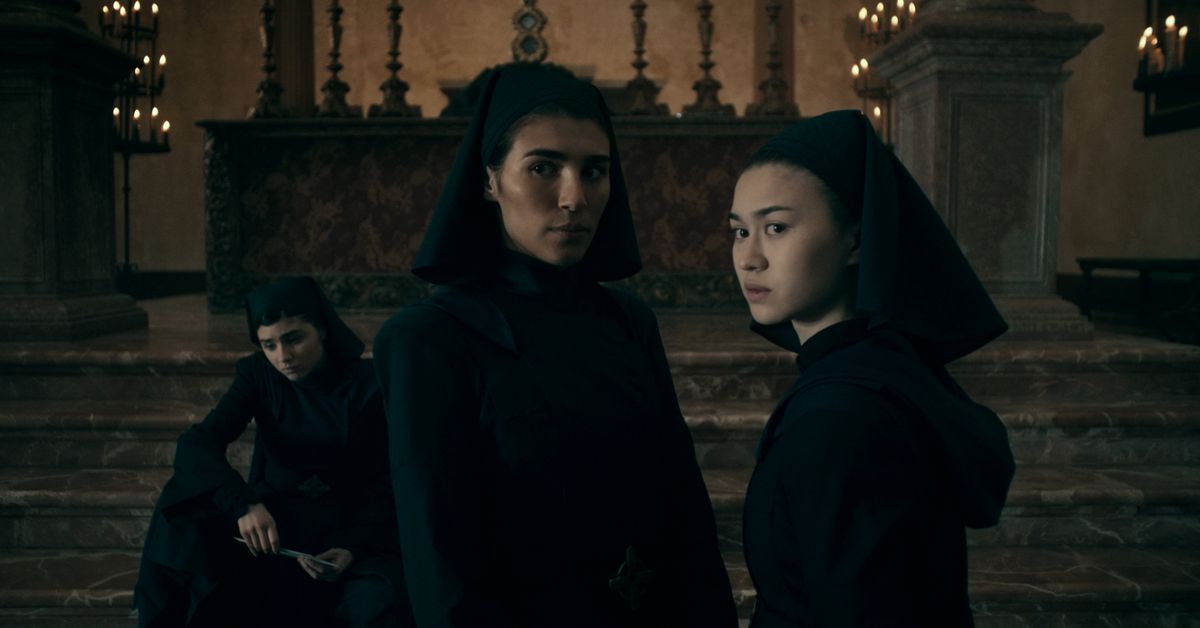 Three young women in all-black nun habits and wimples look suspiciously offscreen in Netflix’s Warrior Nun.