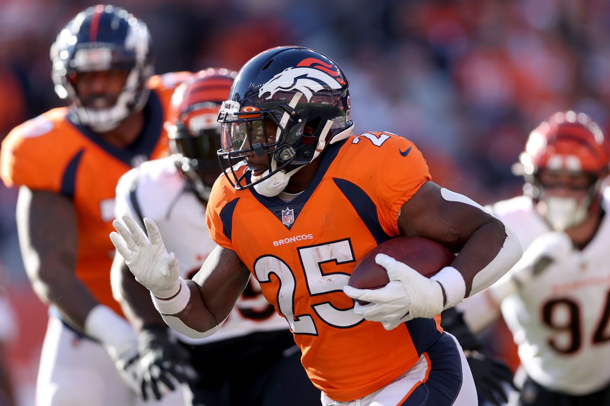 Melvin Gordon III #25 of the Denver Broncos carries the ball against the Cincinnati Bengals at Empower Field At Mile High on December 19, 2021 in Denver, Colorado.