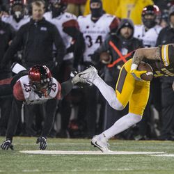 Wyoming\'s Tanner Gentry lunges past San Diego State\'s Damontae Kazee during the second half of an NCAA college football game for the Mountain West championship, Saturday, Dec. 3, 2016, in Laramie, Wyo. (AP Photo/Michael Smith)
