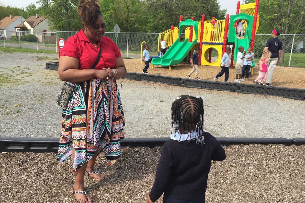 Detroit Pre-K teacher Candace Graham talks to a student on the playground at the Carver STEM Academy. She says her students get "left out a lot" because the school's two other preschool classrooms are in the PNC Grow Up Great program.