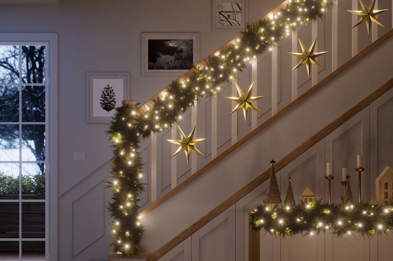 Nanoleaf’s smart holiday string lights lit up and strung over a staircase railing.