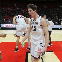 Lone Peak celebrates its win over Pleasant Grove for the 6A basketball championship in the Jon M. Huntsman Center at the University of Utah on Saturday, March 3, 2018.