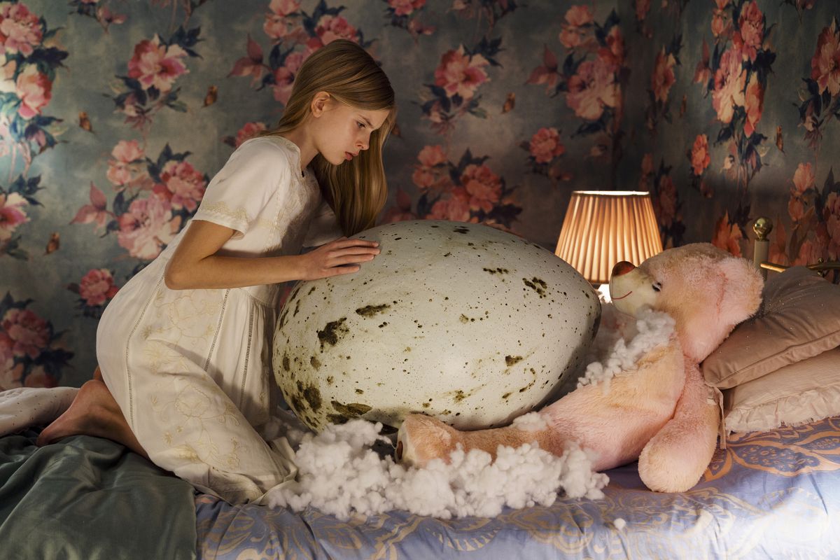 Twelve-year-old gymnast Tinja (Siri Solalinna) hovers over her huge, ferocious egg in Hatching.