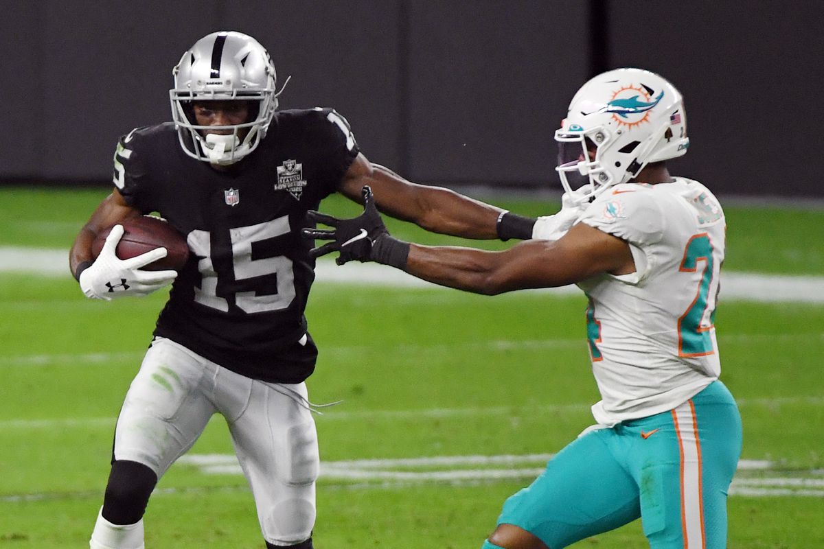 Wide receiver Nelson Agholor #15 of the Las Vegas Raiders avoids a tackle by cornerback Byron Jones #24 of the Miami Dolphins in the second half of their game at Allegiant Stadium on December 26, 2020 in Las Vegas, Nevada. The Dolphins defeated the Raiders 26-25.