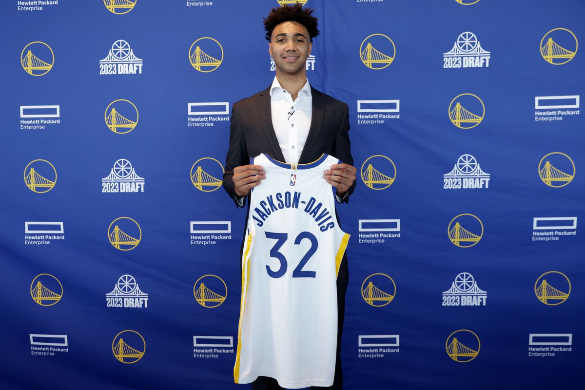 Trayce Jackson-Davis holding up his jersey at a press conference