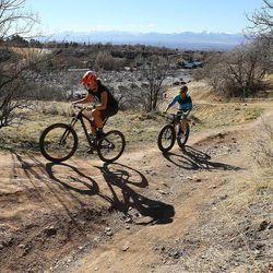 Ami and Chris Stuart go for a ride in Emigration Canyon as warm temperatures Sunday, Feb. 8, 2015, allow numerous activities from skiing and snowboarding, to golfing, biking and hiking along the Wasatch Front.