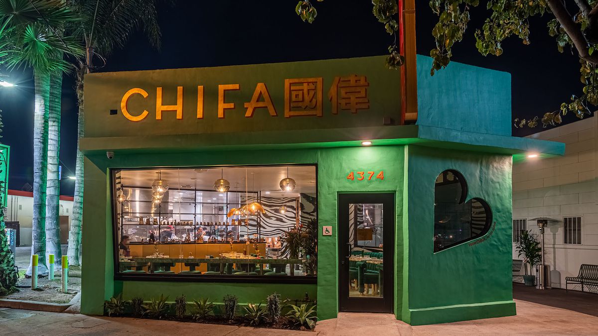 A restaurant painted green at nighttime in Los Angeles.