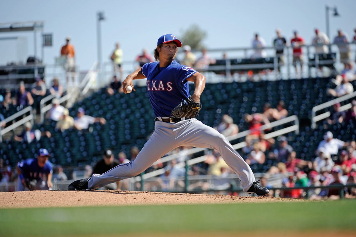 GOODYEAR, AZ - MARCH 13:  Yu Darvish #11 of the Texas Rangers throws a pitch in the second inning of a spring training baseball game against the Cleveland Indians on March 13, 2012 in Goodyear, Arizona.  (Photo by Kevork Djansezian/Getty Images)