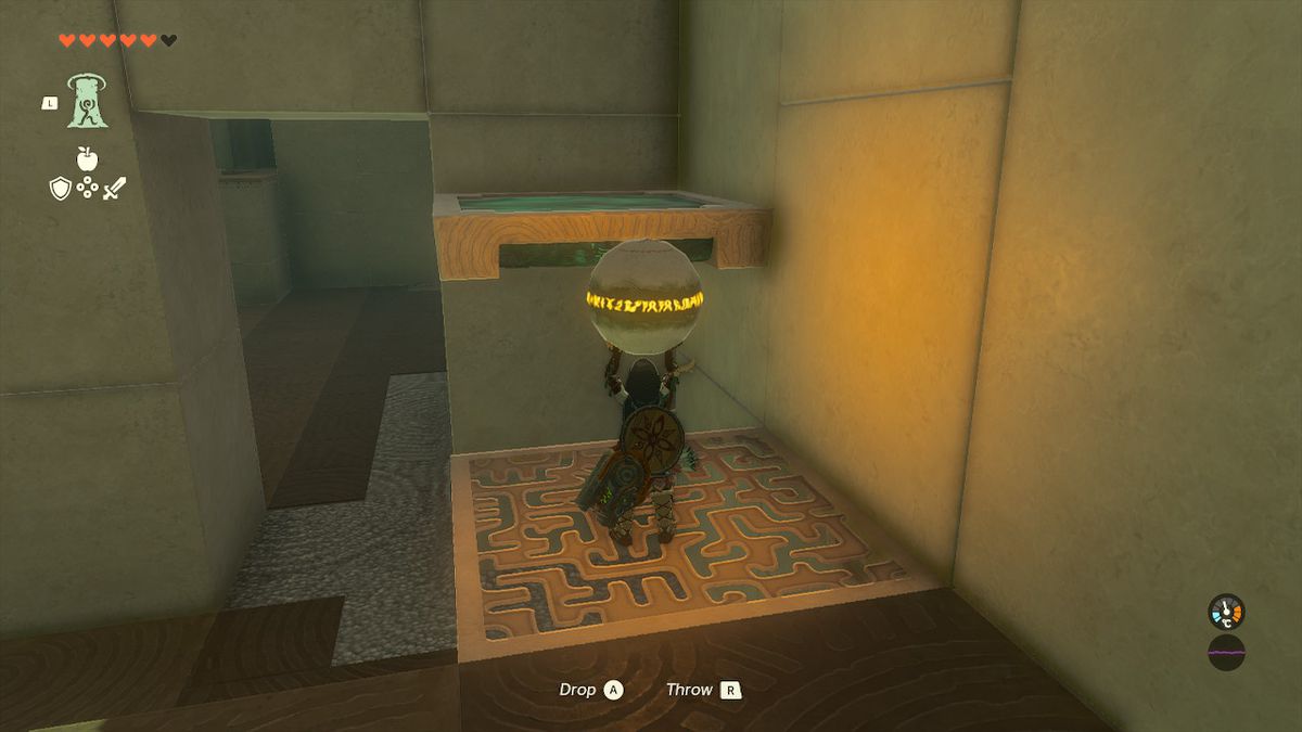 Link holds a ball while standing on a platform in the Orochium Shrine in Zelda Tears of the Kingdom.