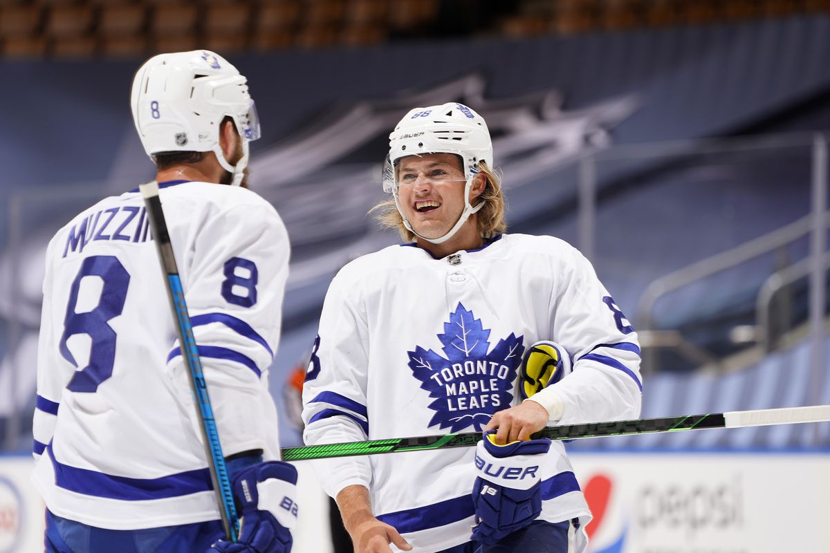 TORONTO, ONTARIO - JULY 28: William Nylander #88 and Jake Muzzin #8 of the Toronto Maple Leafs talk on the ice during the first period of an exhibition game against the Montreal Canadiens prior to the 2020 NHL Stanley Cup Playoffs at Scotiabank Arena on July 28, 2020 in Toronto, Ontario.