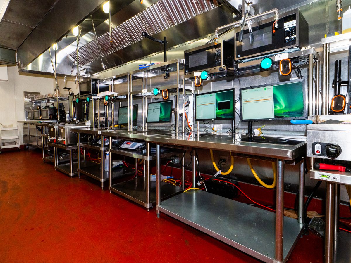 A commercial kitchen hooked up with computer screens.