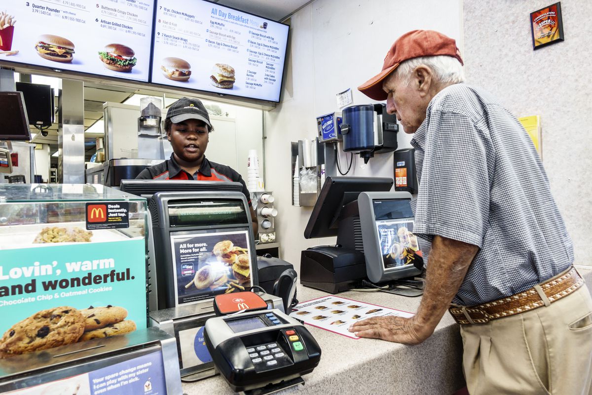 McDonald’s employee takes orders from customers in Vero Beach, Florida.