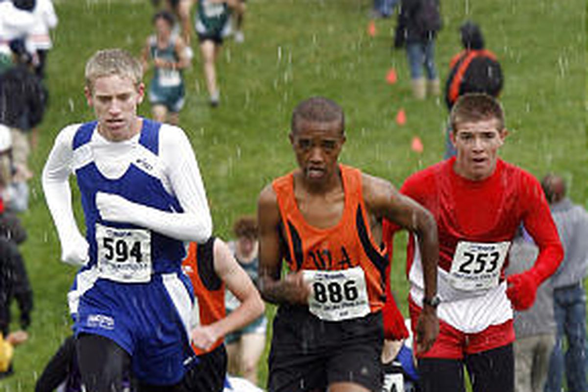 Panguitch's Trac Norris, left, Wasatch Academy's Elijah Rono and Escalante's Cru Cochran battle up a hill in the 1A boys race during the state cross country meet at Sugarhouse Park in Salt Lake City on Wednesday. Rono won the event with Norris taking seco