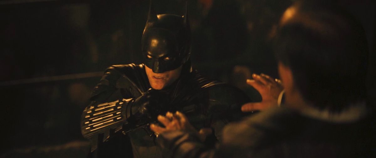 Robert Pattinson’s Batman fights the Penguin in the glow of a fire