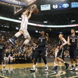 Brigham Young Cougars forward Eric Mika (00) dunks on the Utah State Aggies defense during a game at EnergySolutions Arena on Saturday, November 30, 2013.