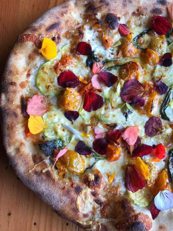 A picture of Lovely’s Fifty Fifty pizza, which comes topped with edible flower petals and squash