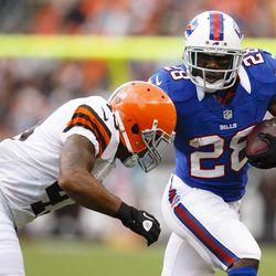 Buffalo Bills running back C.J. Spiller (28) runs the ball as Cleveland Browns strong safety T.J. Ward (43) tries to tackle him during the first quarter at Cleveland Browns Stadium.