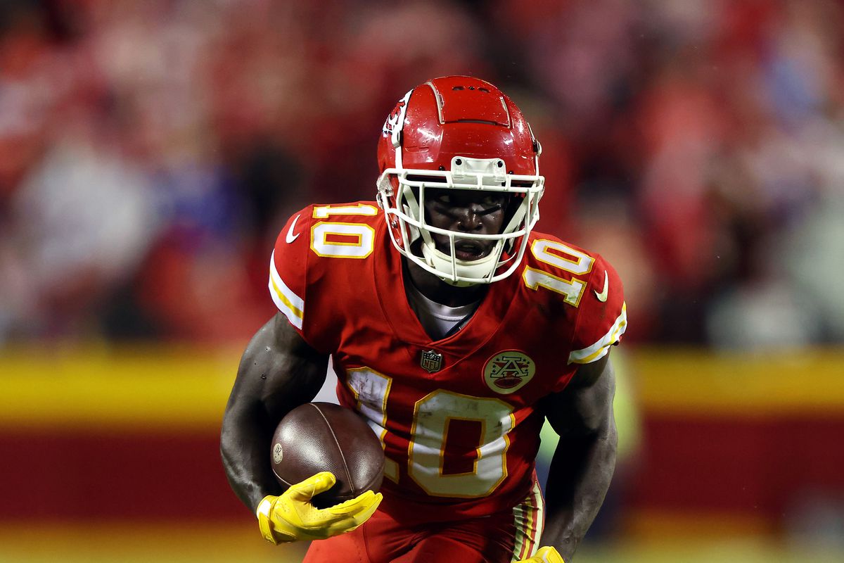 Wide-receiver Tyreek Hill #10 of the Kansas City Chiefs carries the ball during the game against the Buffalo Bills at Arrowhead Stadium on October 10, 2021 in Kansas City, Missouri.