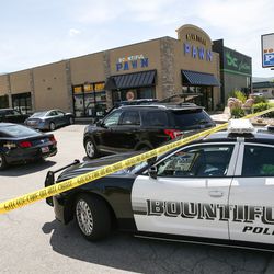 Police investigate a shooting at Bountiful Pawn Shop in Bountiful on Friday, May 4, 2018.