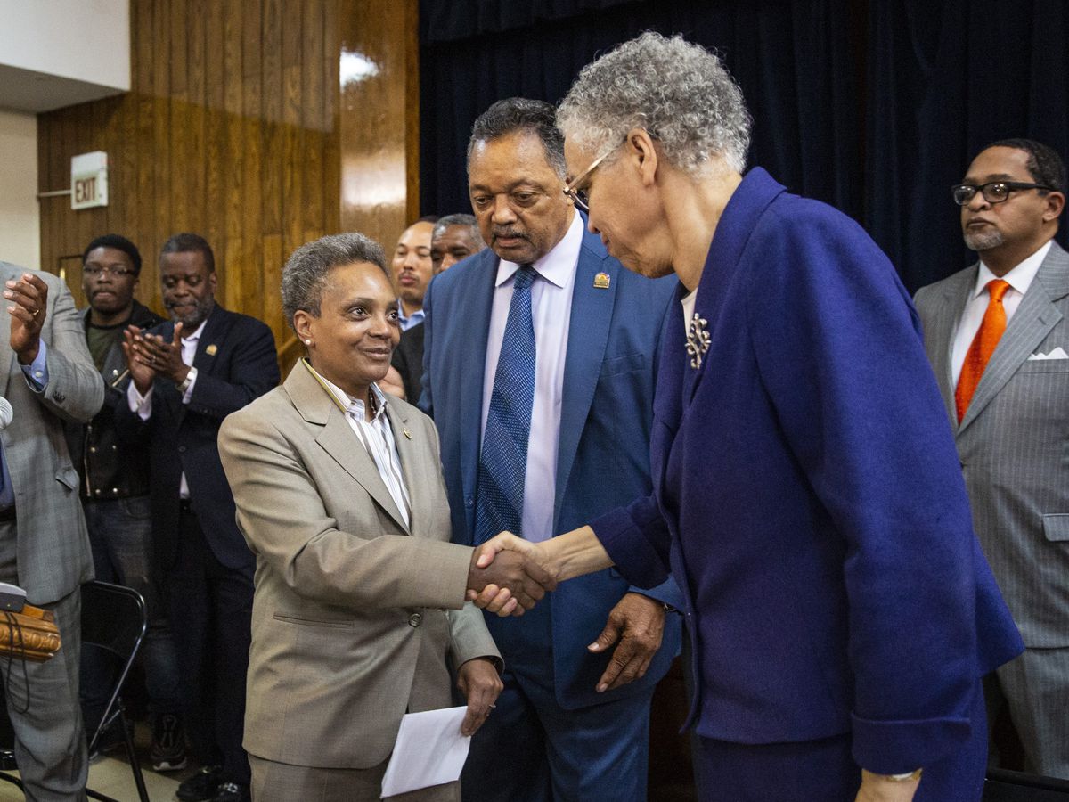Mayor-elect Lori Lightfoot (left) shakes hands with former mayoral candidate Cook County Board President Toni Preckwinkle as Rev. Jesse Jackson looks on during a press conference at the Rainbow PUSH organization April 3, 2019. File photo. | Ashlee Rezin/S